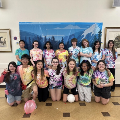 Group photo of young teens wearing tie-dyed shirts